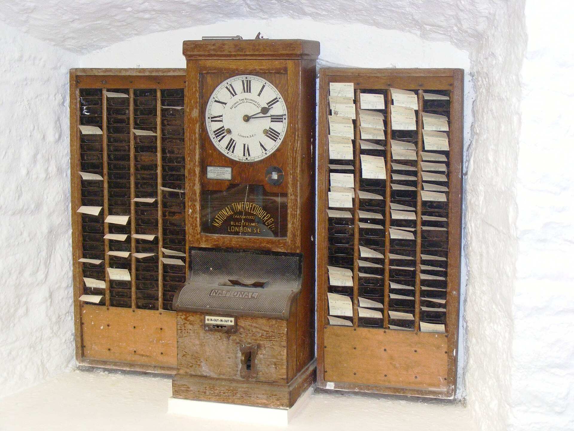 Vintage punch-card time clock used to record hours worked