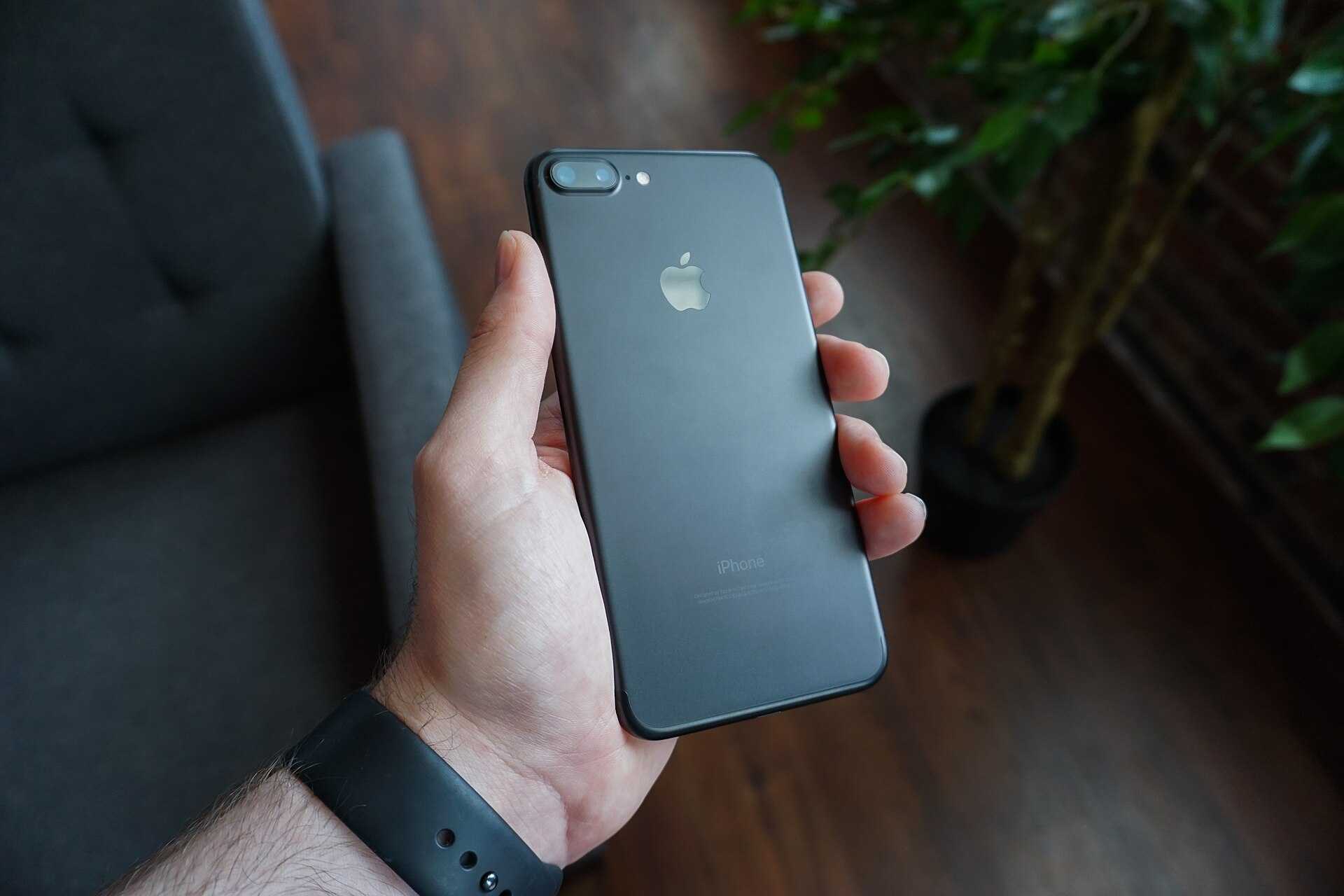 Hand holding a black smartphone