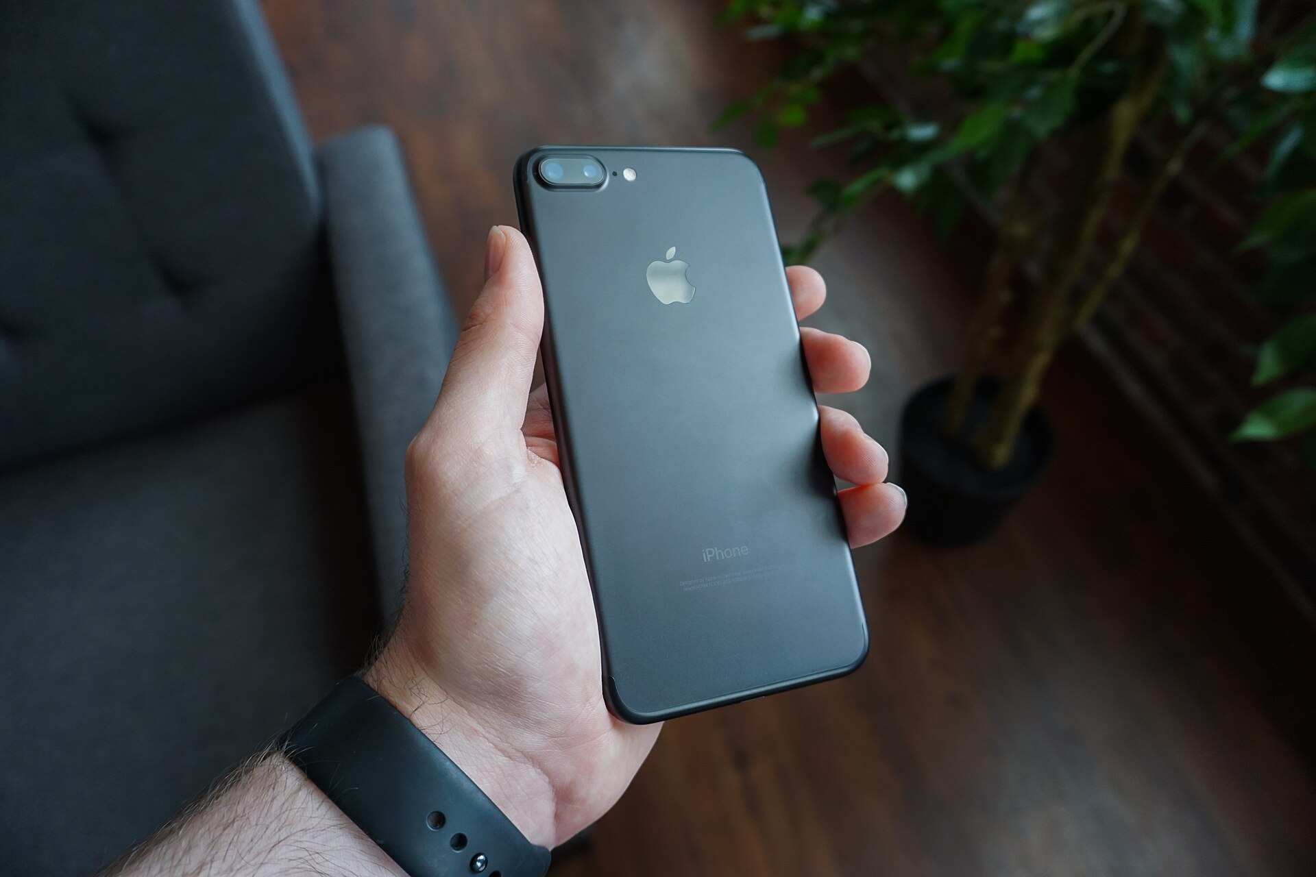 Hand holding a black smartphone
