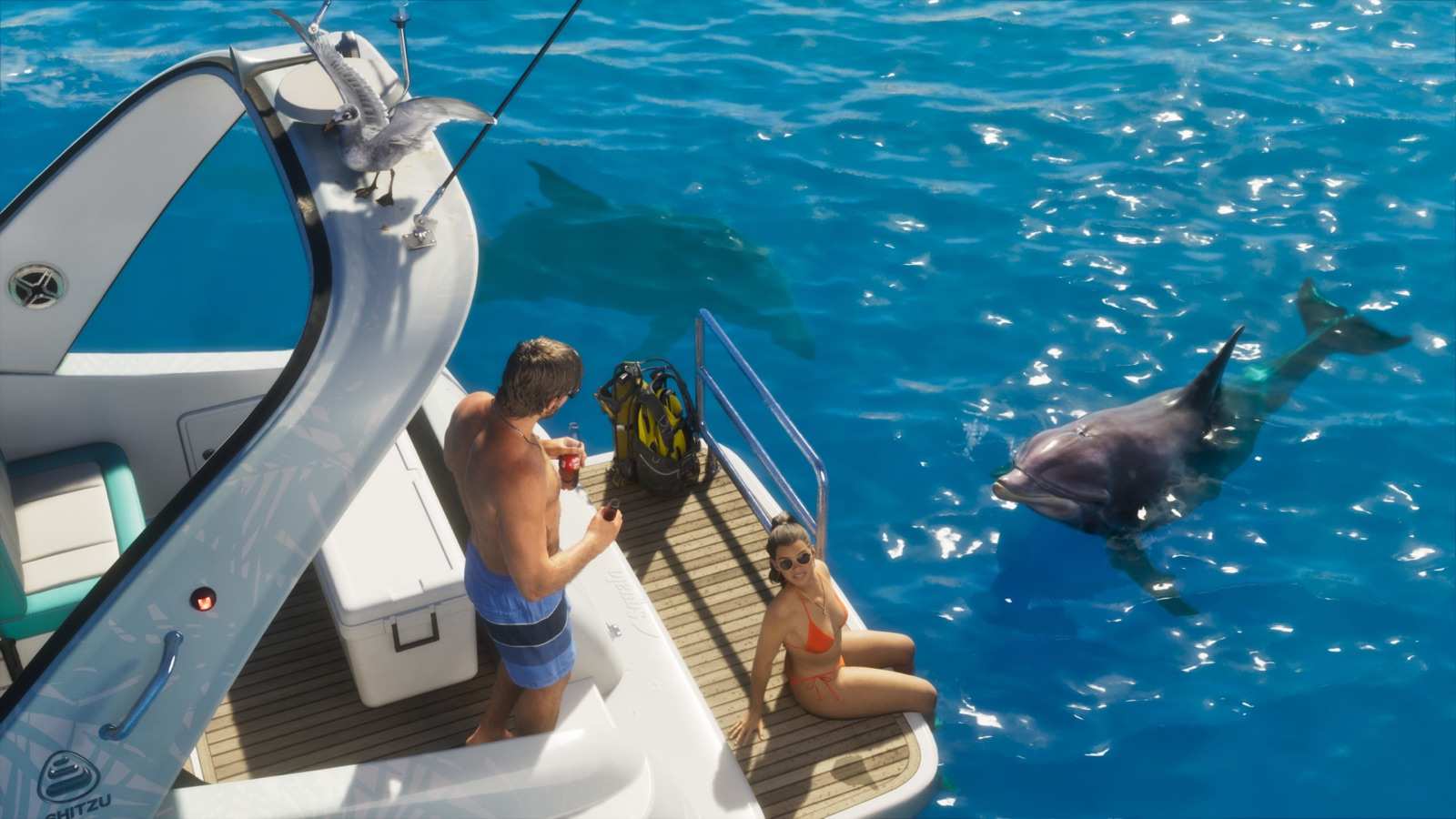 Jason and Lucia on the deck of the Squalo with dolphins swimming alongside
